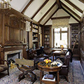 traditional cathedral ceiling Walnut paneled Library with carved details by Felhandler Steeneken Architects