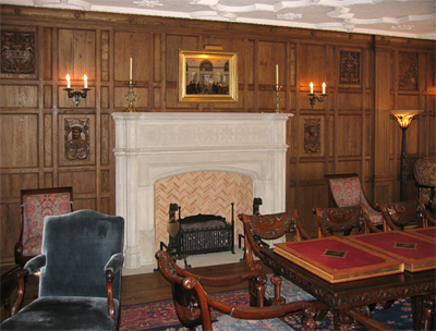 New paneling and carved limestone fireplace mantel in English Tudor Gothic style