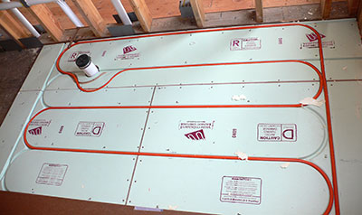 Radiant heat tubing installed in Warmboard aluminum-clad sheathing system